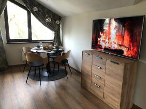 A television and/or entertainment centre at Borovets Forest view (A56)