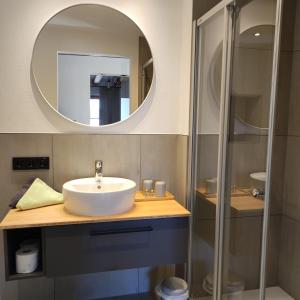 a bathroom with a sink and a mirror at Hotel - Landgasthof Post in Bichlbach