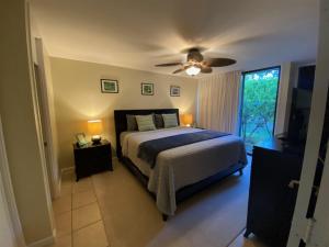 a bedroom with a bed and a ceiling fan at 1 West in Kahuku