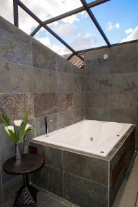 a large bath tub in a room with a window at Atiq Boutique Hotel in Cusco