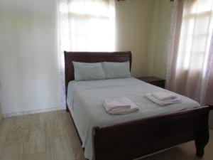 a bedroom with a bed with two towels on it at Villa Sosua Hispaniola Residencial in Sosúa