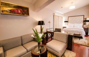 a living room with a couch and a bed at Atiq Boutique Hotel in Cusco