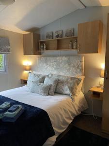 a bedroom with a large white bed with wooden cabinets at The Retreat at The Inn in Spilsby