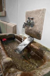 a sink with water coming out of a faucet at Cabinett 1876 in Trittenheim