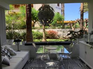 a patio with a glass table and chairs at Yumboparadise in Playa del Ingles