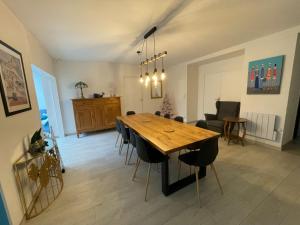 - une salle à manger avec une table et des chaises en bois dans l'établissement Balaena - maison avec jardin proche plage, à Luc-sur-Mer