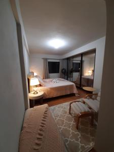 Un pat sau paturi într-o cameră la Casa Schmidt Centro Pedra Azul
