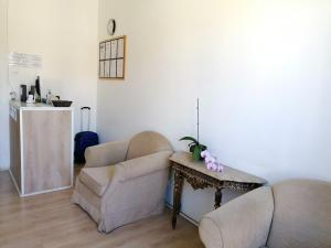a living room with two chairs and a table at Chiado Open World Hostel in Lisbon