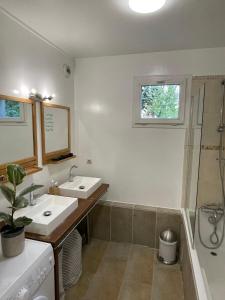 a bathroom with two sinks and a shower at uta house la plaine in Saint-Denis
