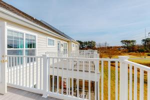 a white porch with a white railing on a house at Kensington Court -- 32759 Kensington in Frankford