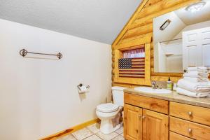 a bathroom with a toilet and a sink at Worthen Cabin in Garden City +23 photos