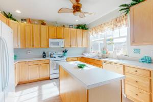 a kitchen with wooden cabinets and a ceiling fan at Kensington Court -- 32759 Kensington in Frankford