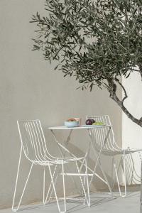 two chairs and a table and a table and a tree at Teal Blue in Koufonisia