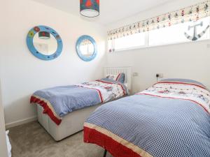 1 dormitorio con 2 camas y ventana en 31 Seaward Crest, en Norwich