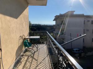 a balcony with a table and chairs on a building at Appartamento Fotia in Giugliano in Campania
