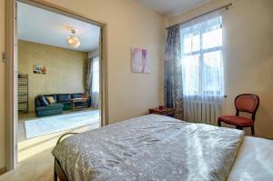 a bedroom with a bed and a large mirror at Romantic City Center Apartment in Old Town in Vilnius