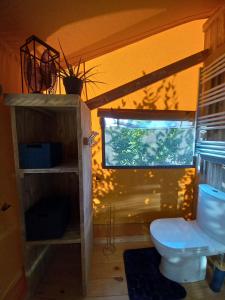 ein Bad mit einem WC und einem Fenster in der Unterkunft LA TENTE DU RANDONNEUR in Rimbach-près-Masevaux