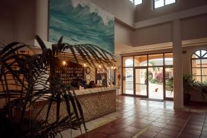 a lobby of a restaurant with a large painting on the wall at La Pared powered by Playitas - Sports Hotel in La Pared