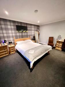 a bedroom with a large bed and a chair at MacArthur House NC500 in Wick