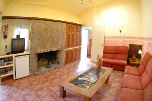 a living room with a couch and a fireplace at Los Molinos in Sanlúcar de Guadiana