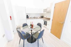 a dining room with a table and chairs in a kitchen at Modern Apartment in Salford Manchester UK in Manchester