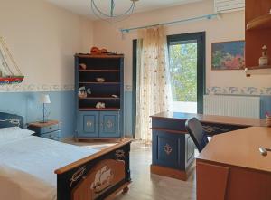 a bedroom with a bed and a desk and a window at Spacious House in a Quiet Neighbourhood in Ierapetra