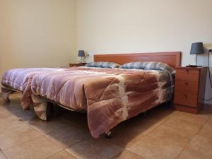 a bedroom with a bed with a blanket and a dresser at Pagés in Sant Climent Sescebes