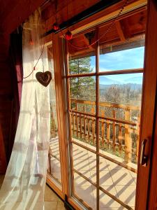 a window with a heart hanging on a curtain at Romantic Cottage House in Žužemberk