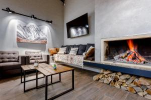 a living room with a couch and a fireplace at Hotel Tsiga in Gudauri