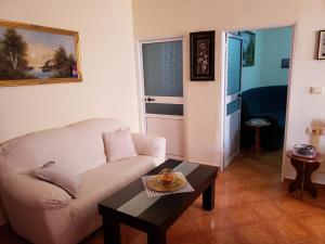 a living room with a couch and a table at Malsi 2 Bedrooms Apartment in Vlorë