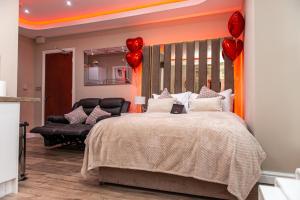 Un dormitorio con una cama grande con corazones rojos. en Meridian Serviced Apartments, en Bradford