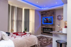 a bedroom with a large bed and a fireplace at Meridian Serviced Apartments in Bradford