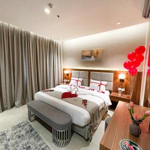 a bedroom with a large bed and red balloons at سيتيز إن للشقق المخدومة in Yanbu