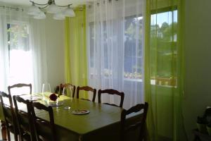 a dining room with a table and chairs and a window at baratzean in Uhart-Cize