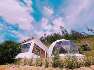 a house on top of a hill with a dome at Glamping NIDO VERDE in Iza