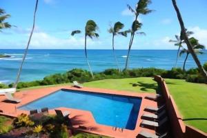 a view of a swimming pool and the ocean at Luxury 2-Story Oceanfront Condo w/ Views & Pool in Wailua