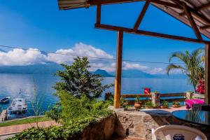 a view from the patio of a house overlooking the water at Hotel Terrazas Del Lago in San Antonio Palopó