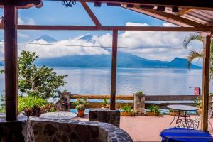 a patio with a view of a lake and mountains at Hotel Terrazas Del Lago in San Antonio Palopó