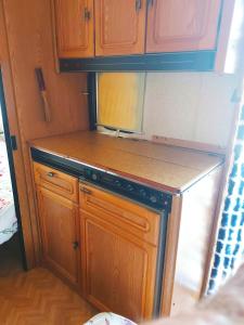 a kitchen with wooden cabinets and a counter top at Mi Cachito in Los Caños de Meca +39 photos