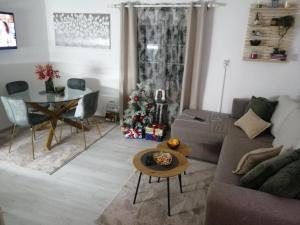 a living room with a couch and a christmas tree at ZOĆEVIĆA KONAK in Petrovići