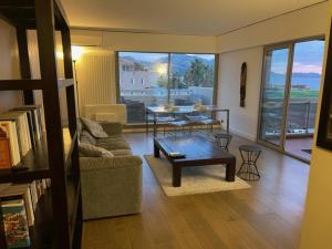 a living room with a couch and a table at PRADO PLAGE in Marseille