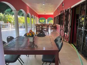 a dining room with tables and chairs in a restaurant at Hacienda De La Bahia in Arroyo Barril