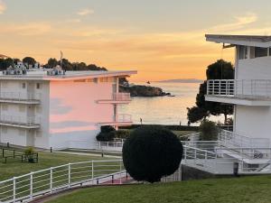 ein Gebäude mit einem Busch vor einem Gewässer in der Unterkunft Almadrava Beach in Roses + 54 Fotos