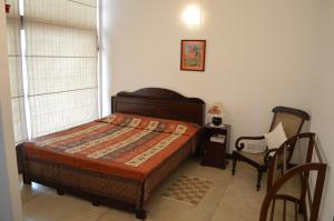a bedroom with a bed and a chair at Star Class Comfort in Capital City in Battaramulla