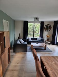 a person with their feet up in a living room at Recreatiewoning Maas en Waal 72 in Ewijk