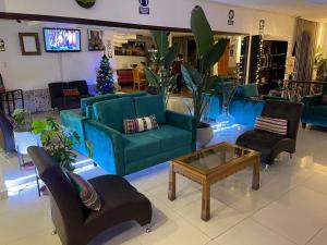 a living room with blue couches and a coffee table at CasaHotel Jockey Plaza Mall in Lima