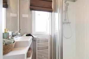 a bathroom with a sink and a shower with a window at gemütliches, voll ausgestattes Tiny House in Vilseck +11 photos
