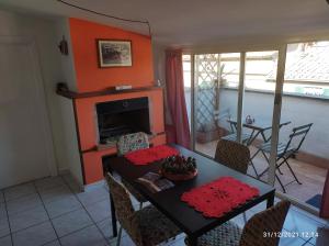 a dining room with a table and a fireplace at La casa di Rick in Ronciglione