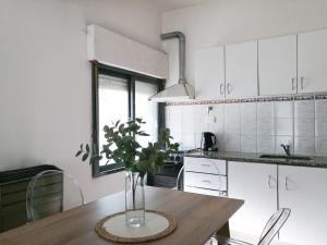 a kitchen with a table with a vase on it at Departamento para 2 o 4 personas in Neuquén
