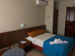 Ένα ή περισσότερα κρεβάτια σε δωμάτιο στο Luz de Aurora HOTEL